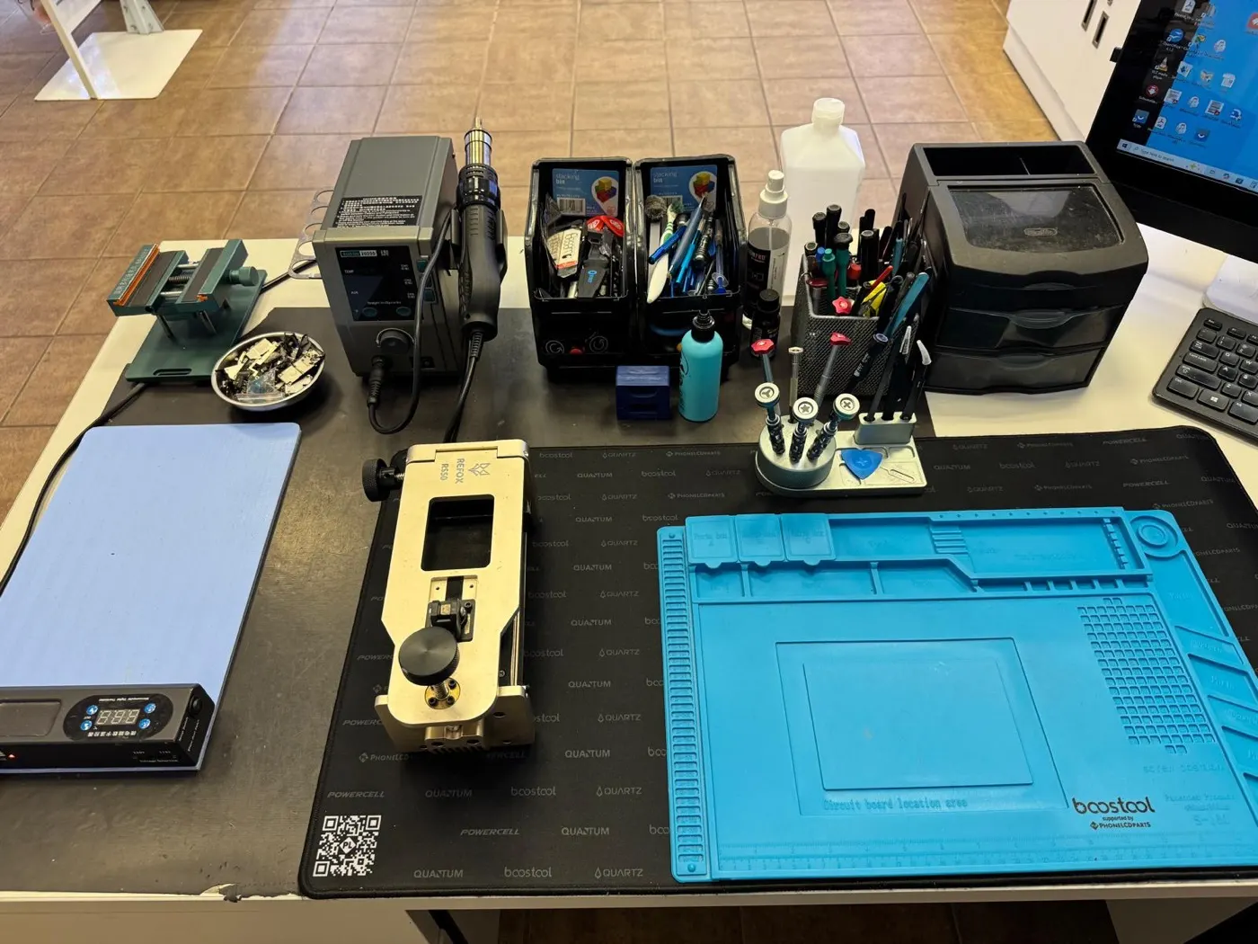 The iFix repair bench with tools on a blue silicone mat